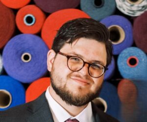 Chris, the new AmeriCorps VISTA leader, smiling toward the camera